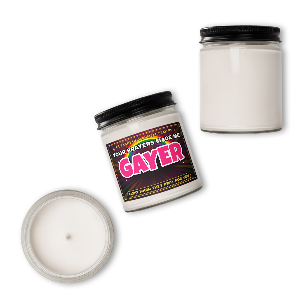 Overhead view of the Nice Gay soy candle labeled "Our Lady of Backfired Prayers" and "Your Prayers Made Me GAYER," with the plain back of a jar and an open jar showing the wax and wick.